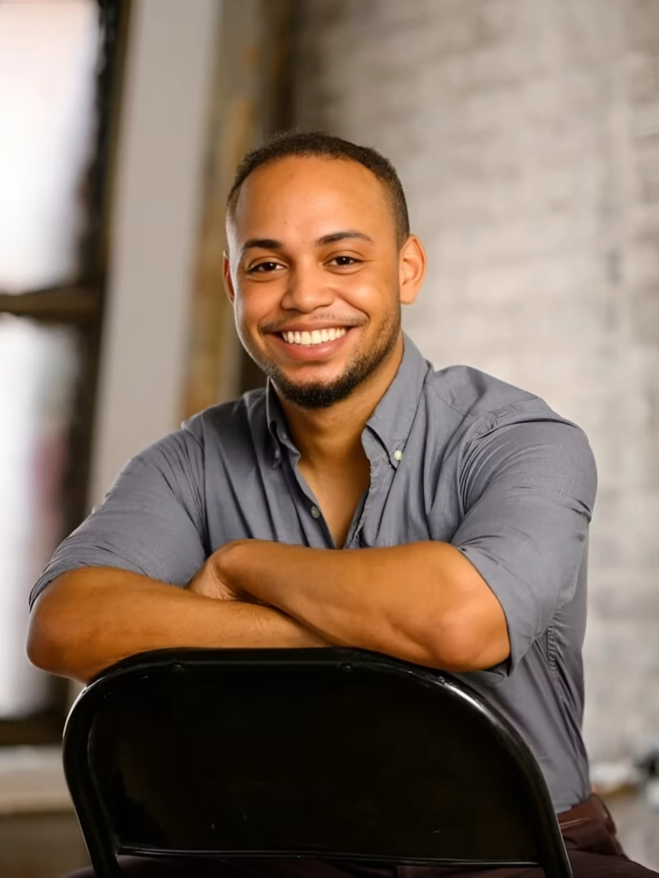 Portrait of a smiling man with arms crossed