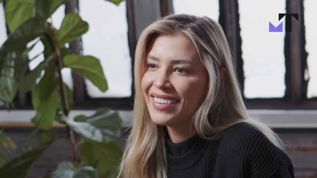 Portrait of a smiling woman near greenery